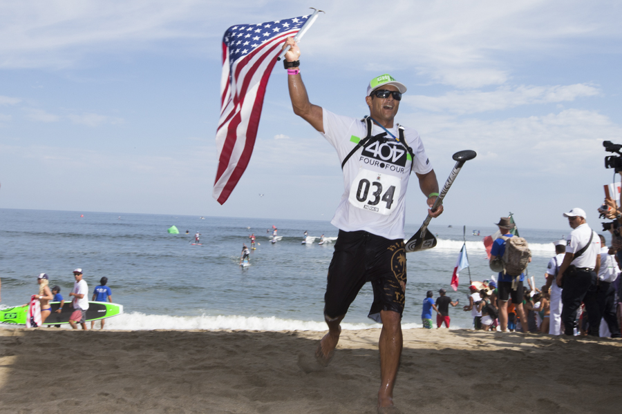 USA's Danny Ching, crossing the finish line placing first and earning the Gold Medal in his ISA debut in the SUP Long Distance Race. Photo: ISA/Bielmann