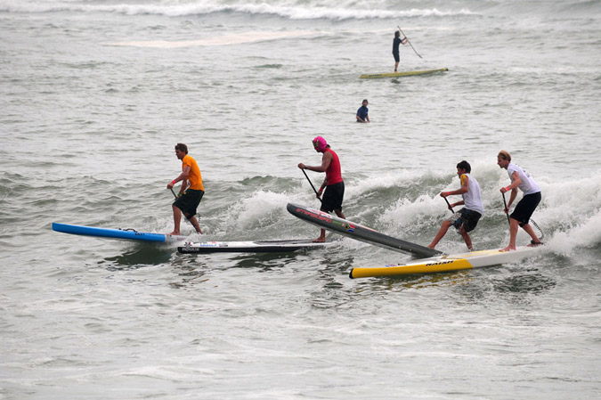 Jamie Mitchell (AUS), Fernando Stalla (MEX), Dylan Frick (RSA), and Ollie Shilston (GBR), from left to right, led the pack in Heat 1 of the Men’s SUP Technical Race. Photo: ISA/Tweddle