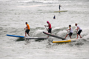 Jamie Mitchell (AUS), Fernando Stalla (MEX), Dylan Frick (RSA), and Ollie Shilston (GBR), from left to right, led the pack in Heat 1 of the Men’s SUP Technical Race. Photo: ISA/Tweddle